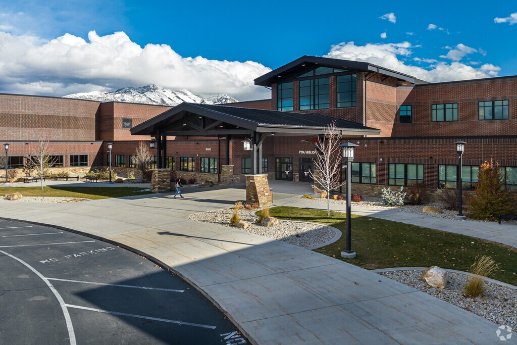 A student walks towards the entrance at Skyridge High School in Thanksgiving.