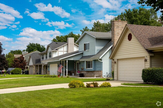 Traditional homes sit with manicured lawns.