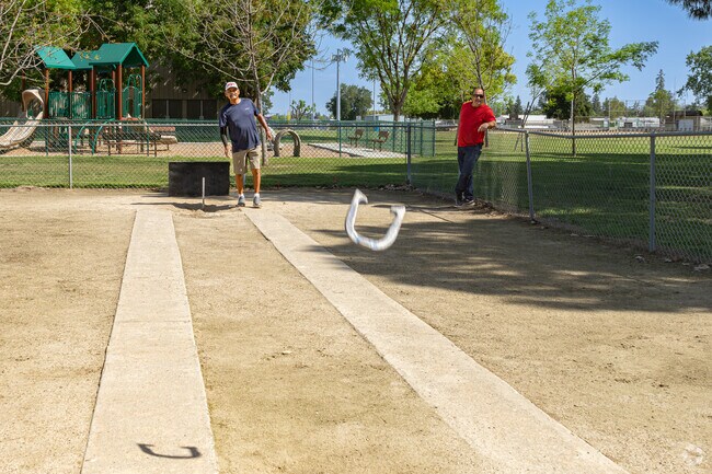 Two Tulare friends meet up regularly to play a game of horseshoes at the nearby park.