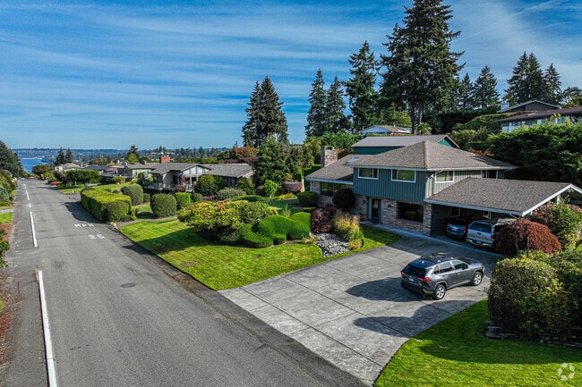 The neighborhood features various architectural styles, including split-level and ranch styles.