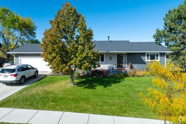 A classic ranch‑style home sits on a tree‑dotted lot.