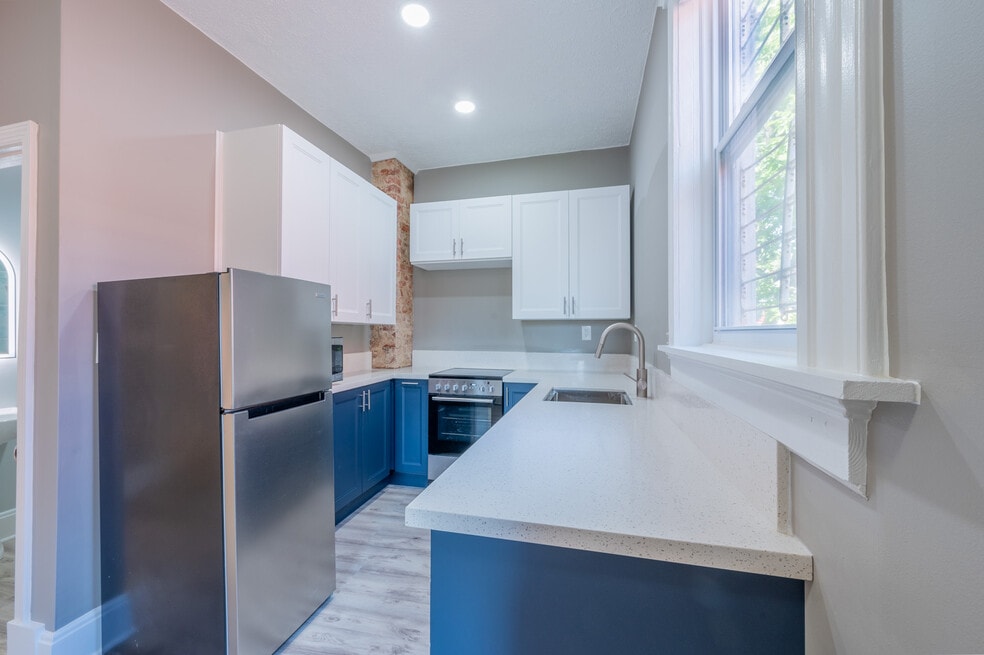 Kitchen with brand new stainless appliances including dish washer and Quartz countertops!