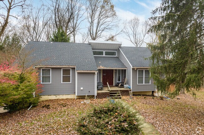 A midcentury home sits nestled among tall trees in a cul-de-sac in East Caln.