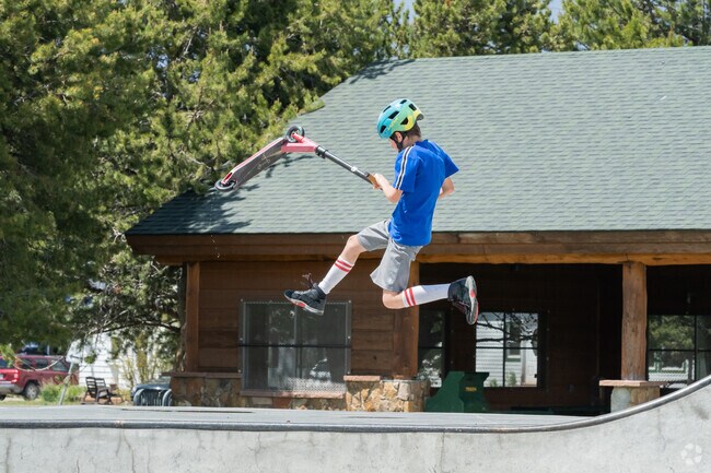A scooter rider gets airborne for his tricks at the skatepark in Polhamus Park.
