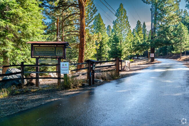 Juniper Hills entrance sign welcomes residents to a quiet mountain enclave.