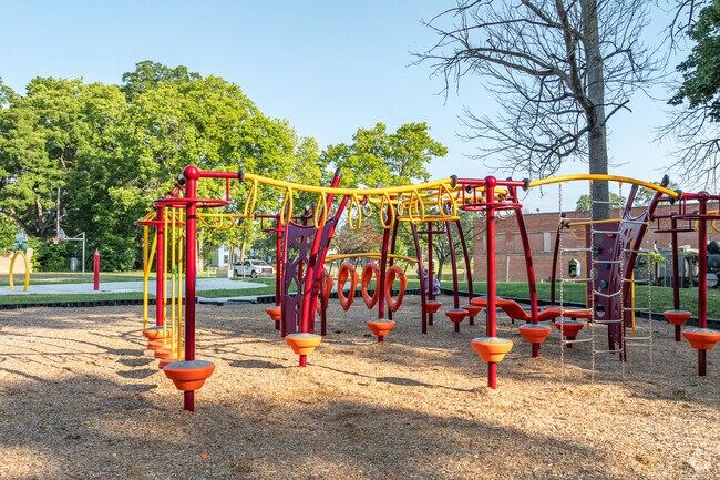 Five Oaks Park offers a splash pad, playground, and fitness equipment in a green space.