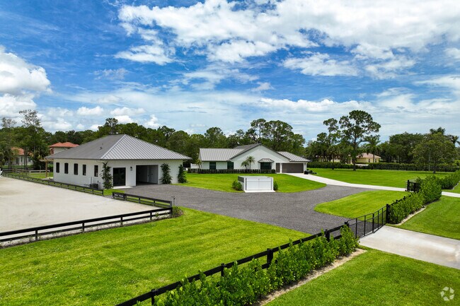 Beautiful landscape around the large ranch style home in Paddock Park of Wellington neighborhood