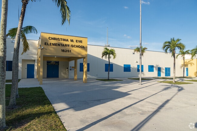 Christina M. Eve Elementary School's main entrance under a stunning sunset.