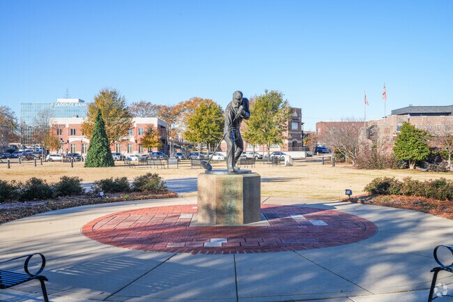 Visitors admire the Elvis Presley Homecoming Statue, a landmark of pride in Tupelo.