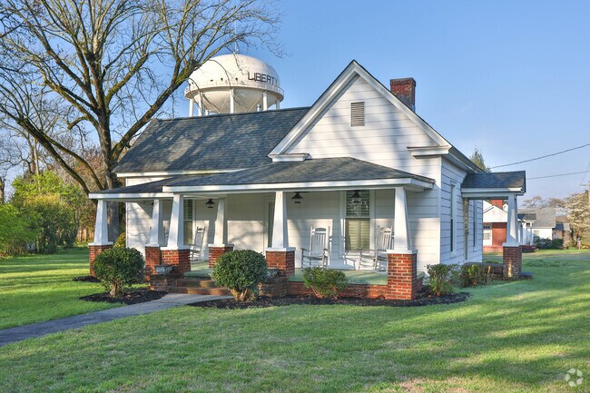 Bungalow Home In Liberty With Town Water Tower Behind
