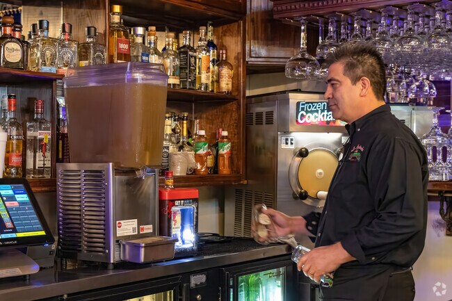 The bartender orchestrates The Thicket's ambiance with flair.