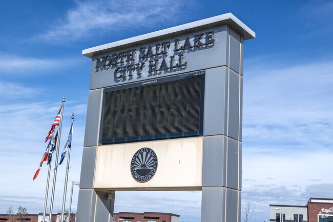 Flags wave next to an electronic sign at North Salt Lake City Hall.