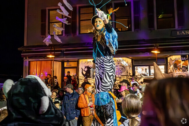 Stilt walkers lead the procession during the Collinsville Halloween Parade.