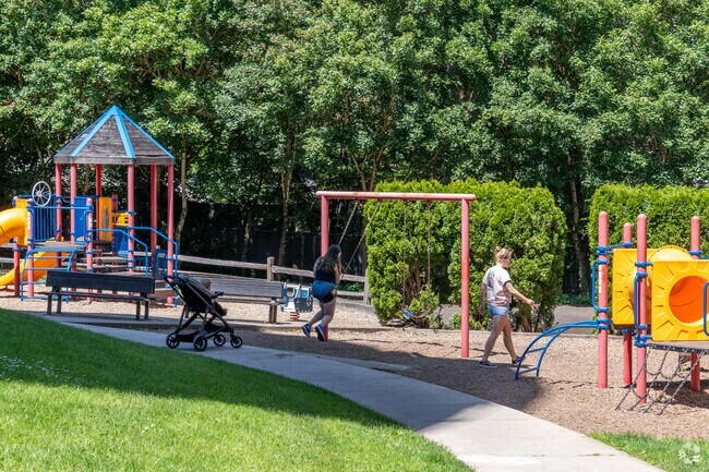 Families enjoy the playground at the Water Tower Park.