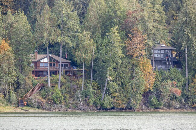 Custom cabins are tucked among lush evergreens along the shoreline in Seabeck.