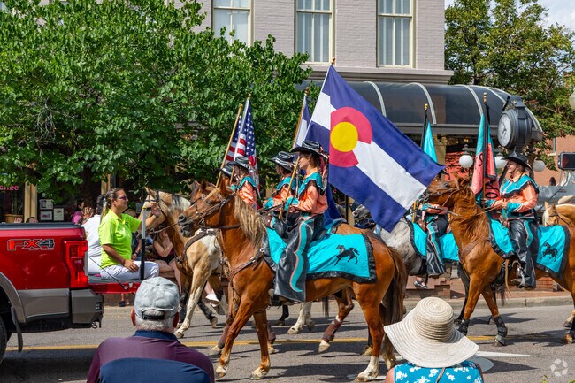 A parade of horses walk through Downtown Golden during the Buffalo Bill Days event.