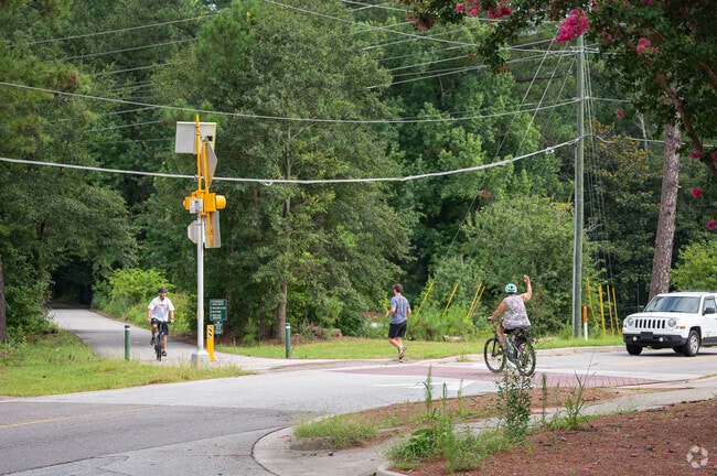 Bikers and runners both share the trail at the North Augusta Greeneway Trailhead.