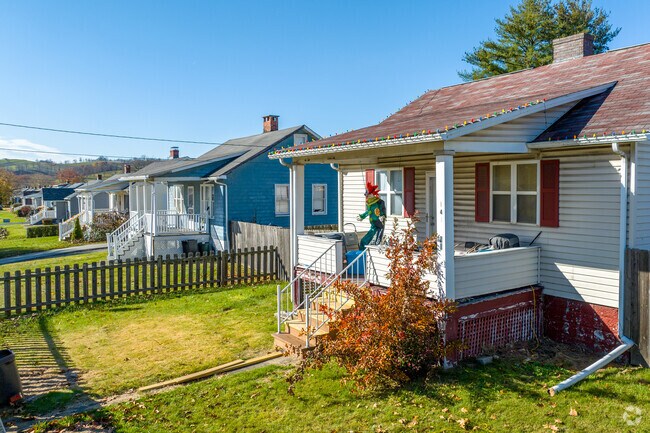 Single story cape cods sit aside each other with small yards in Perry.