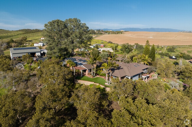 Custom built Mediterranean styled home with acres of land in the foothills of South Morro Hills.