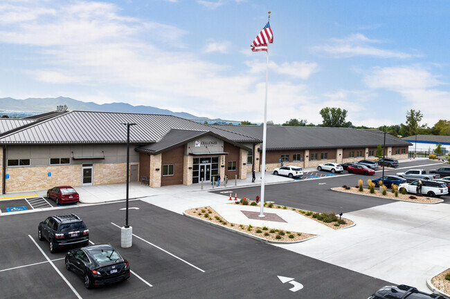 An American Flag waves in front of Challenger School.