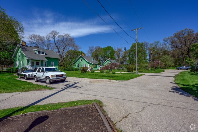 Three bungalows sit along Barton Pond in Barton Hills.