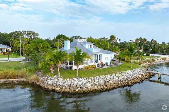 Feel the river breeze from your backyard at this direct water access Roseland home.