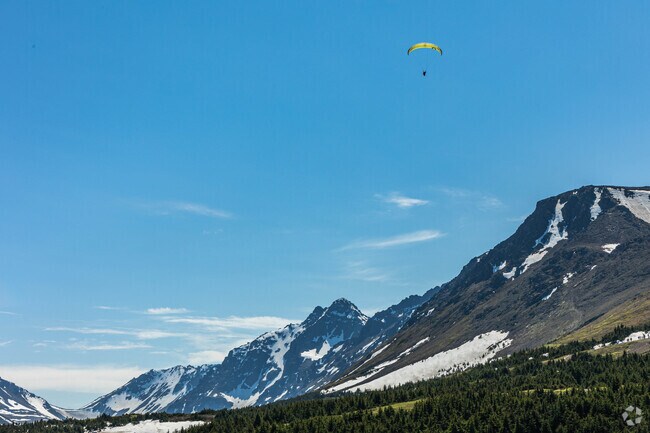 A paraglider launches off Flattop Mountain at the Glen Alps Trailhead in Hillside East.