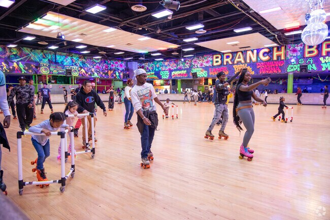 People enjoy roller skating at the Holiday Glow Party in Branch Brook Park Roller Skating Center.