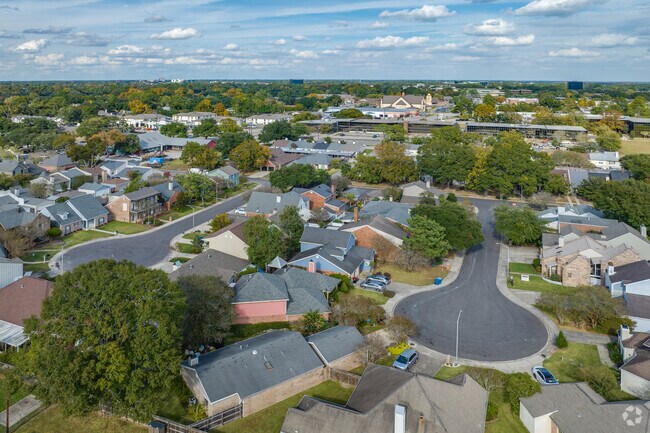Neighboring subdivisions on small lots with large houses near shopping in Bois De Lafayette.