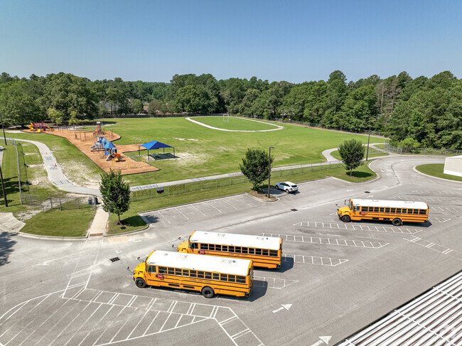 Buses parked in front of play area at Martinez Elementary School in Augusta, GA.