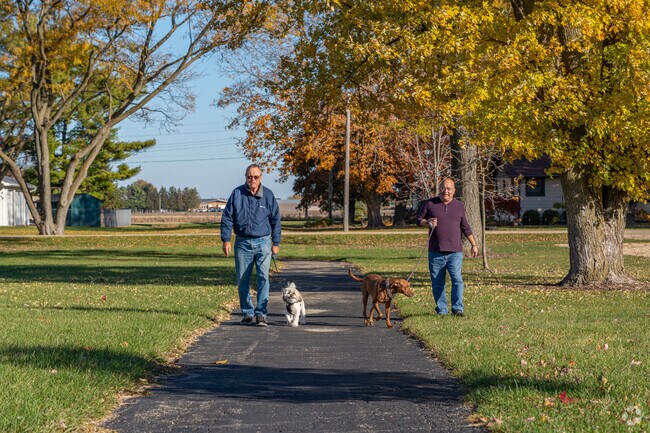 Residents of Malta enjoy walking the paved walkway in Lions Park.