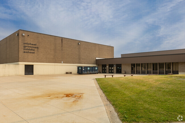 Grimmer Middle School's entrance is flanked by benches.