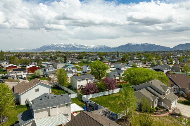An aerial view of Roy from above, possibly showcasing the city's grid-like street pattern and surrounding mountain ranges.