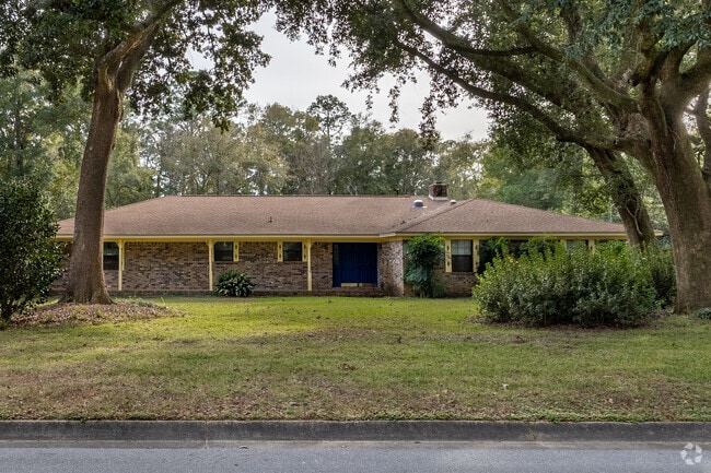 Mature trees shade brick ranch-style homes from the 1970s–80s.