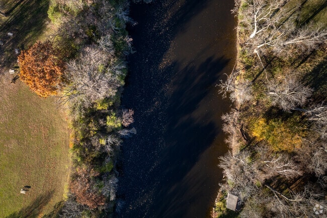 Milwaukee River winds through Kletzsch Park, a popular spot for fishing in Parkway.