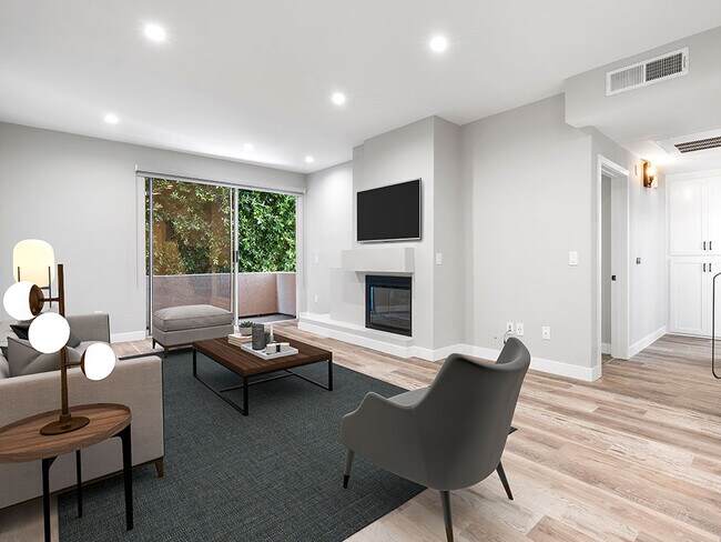 Living Room with hardwood floors, fireplace, and direct patio access.