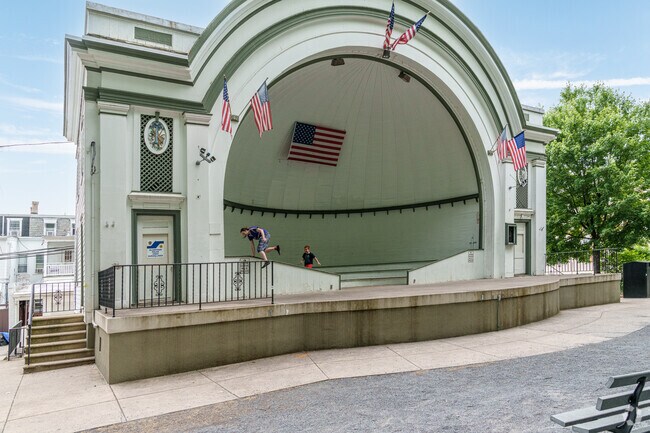 A dad shows his son his parkour moves at the West Park band shell in Allentown.