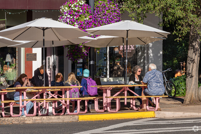 Mountain Meadows residents enjoy their coffee on the sidewalk picnic tables of downtown.