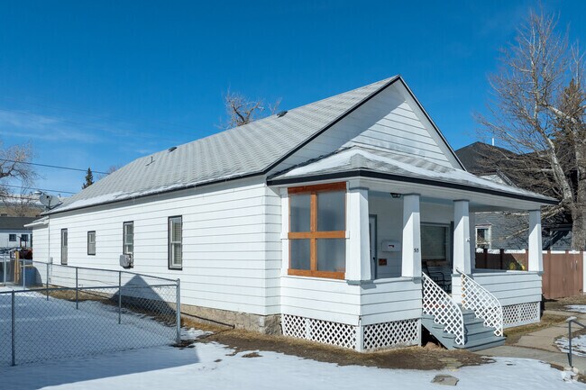 This Folk Victorian home in Rawlins features a charming gable roof and cozy front porch.
