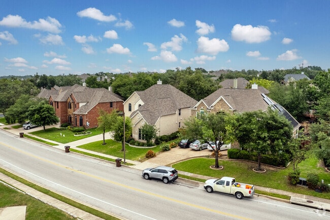 Mature trees and well‑kept homes line Forest Creek’s sidewalks.