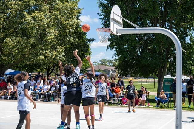 The kids are having fun playing basketball at Champaign-Urbana Days held in Douglass Park.