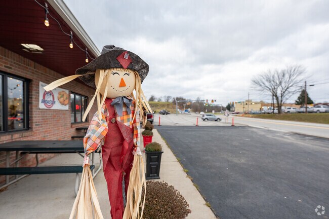 A happy scarecrow greets patrons of Grande Jr Pizza Express in Meadow Lands.