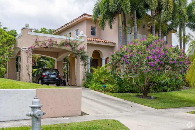 Mediterranean home with a carport and colorful garden in Prospect Heights.