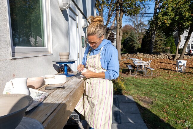 An artist preps art for the next stage at the Silvermine Arts Center.