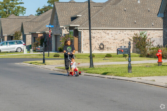 A family goes for a stroll along a quiet Maplewood neighborhood street.