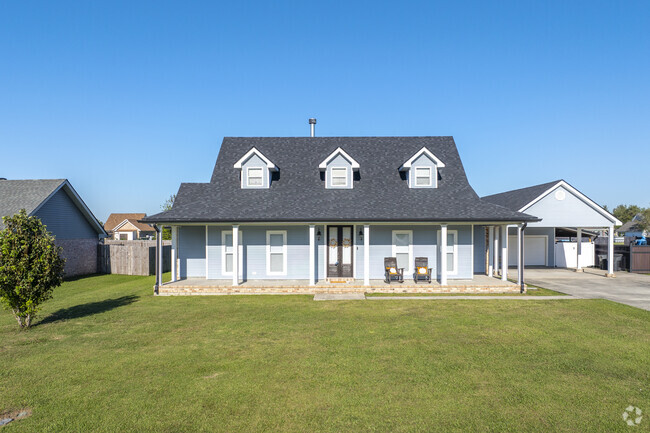 A Cape Cod home with a spacious front porch in Bourg perfect for enjoying a hot Louisiana day.