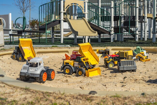 Kids can play with trucks in the sandbox at John Waples Memorial Playground.