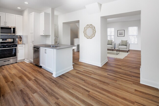 Kitchen, living, and dining areas with hard surface flooring