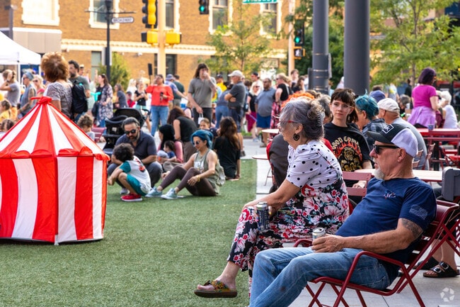 Crowds of people gather at Folkways Night Bazaar Circus in Downtown Fargo's Broadway Square.