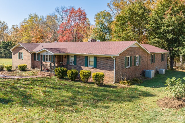 A large brick rancher showcases the vibrant fall colors of Northeast Winston-Salem.
